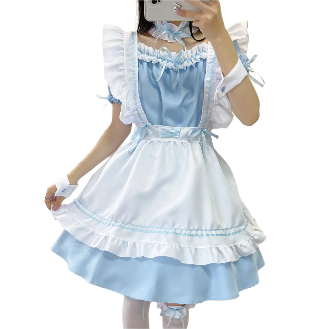 Person wearing a light blue and white dress with ruffled details, standing in front of a mirror.