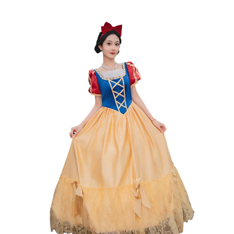 Person in a Snow White costume standing in front of a castle.