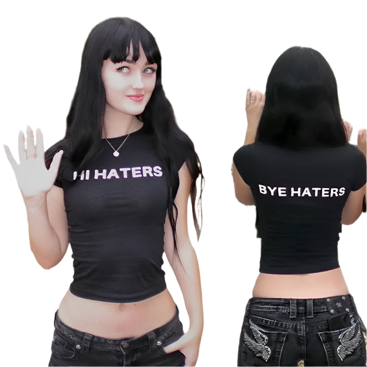 Two individuals wearing black and white t-shirts with the text 'HI HATERS' and 'BYE HATERS' on them, standing in an outdoor setting with a staircase and trees in the background.