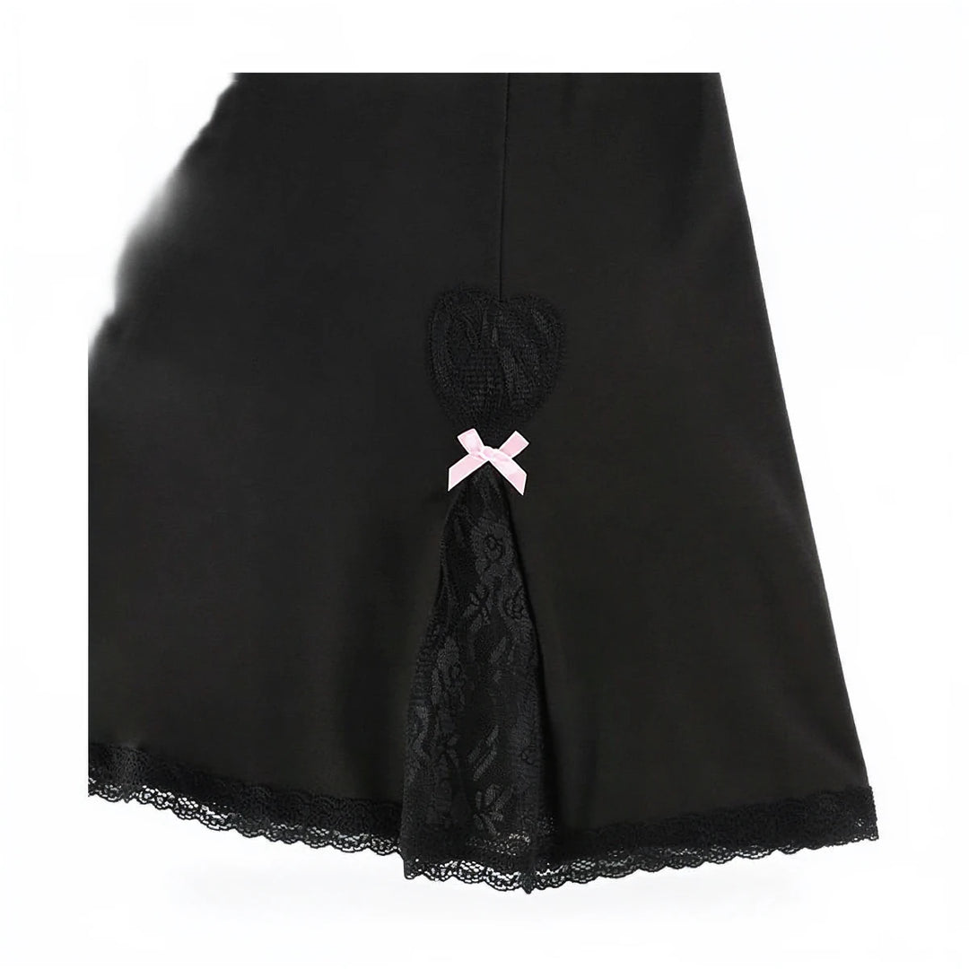 Black sundress with lace trim and pink bow accent at back.