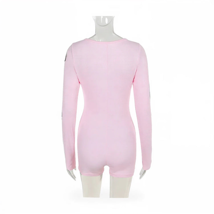 Pink long-sleeved playsuit with subtle seam detailing and sleeve accents.