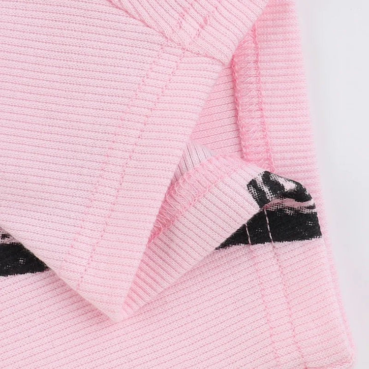Black and pink textured knit playsuit with ribbed detailing.