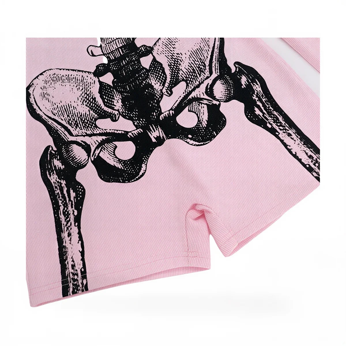 Pink ribbed playsuit with black skeletal hip bone graphic print.