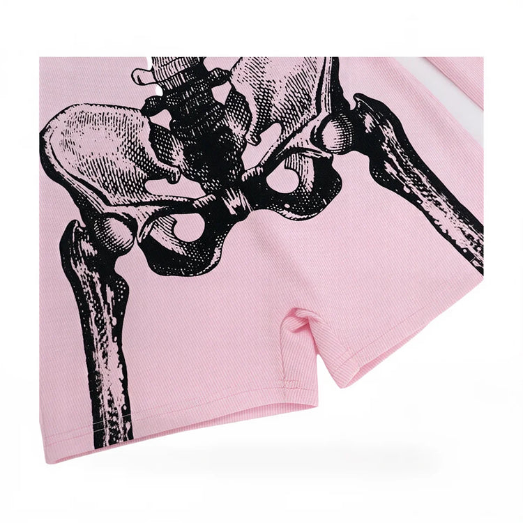 Pink ribbed playsuit with black skeletal hip bone graphic print.