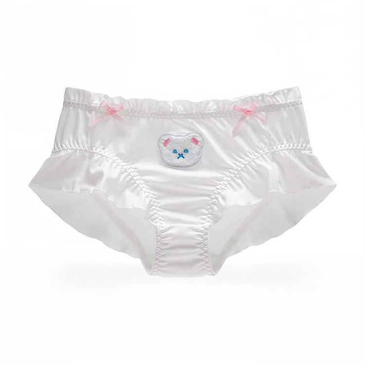 White satin panties with ruffled edges, pink bows, and embroidered bear face.