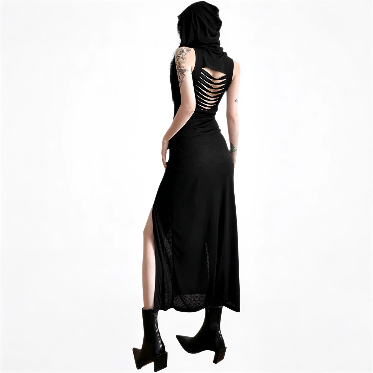 Black sleeveless dress with back cutouts and side slit, made of flowing fabric.