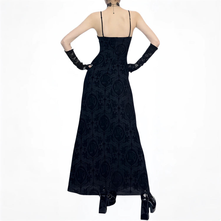 Black velvet gothic dress with intricate embroidery and thin straps.