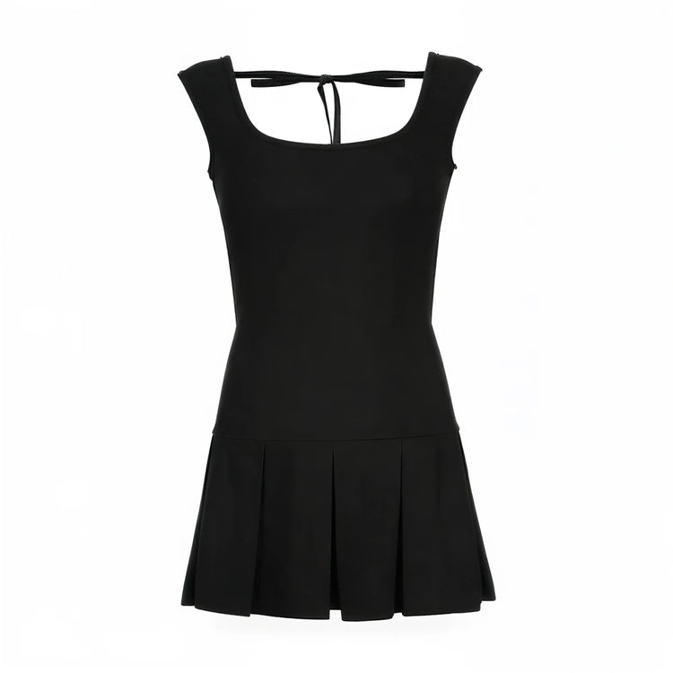 Backless mini dress in black, fitted bodice with pleated skirt and tie-back detail.