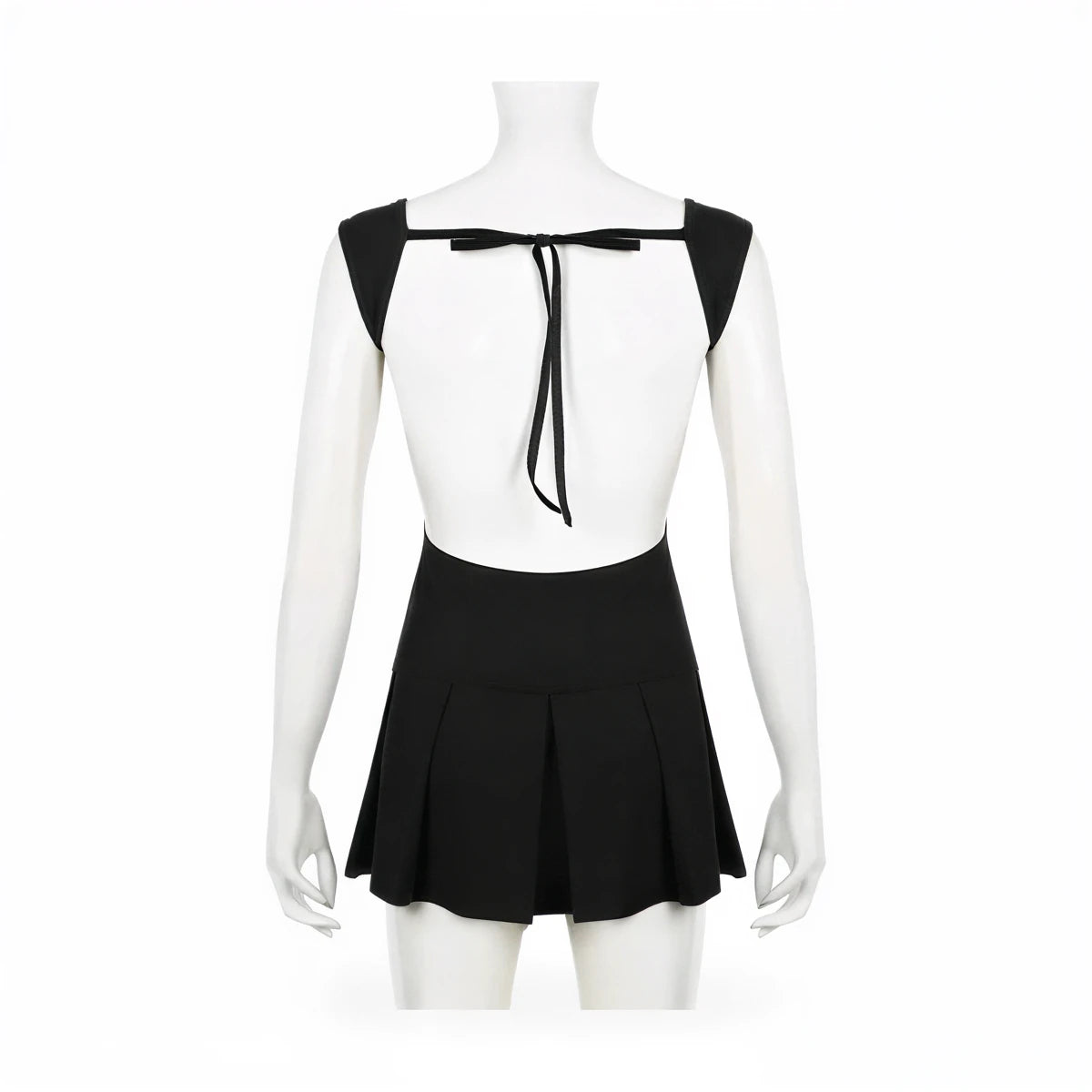 Backless mini dress in black, featuring tie-back detail and pleated skirt.