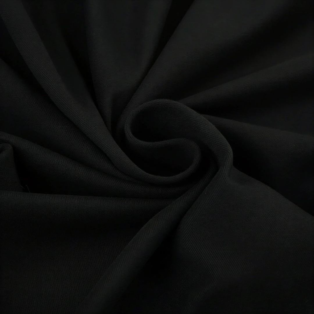 Backless mini dress in black, soft fabric with subtle texture and gathered detail.
