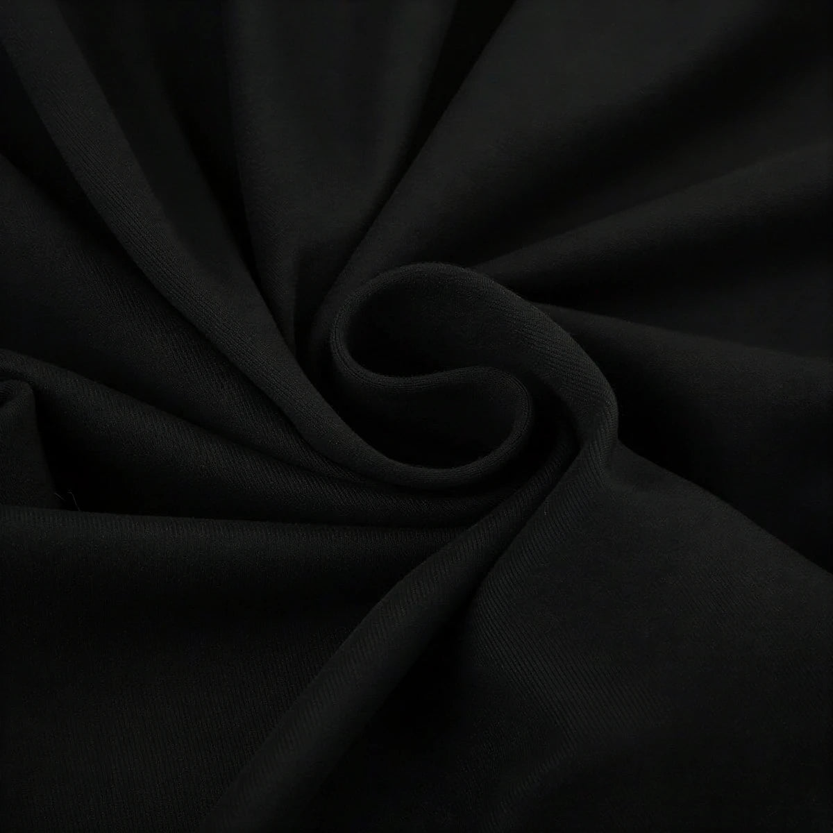 Backless mini dress in black, soft fabric with subtle texture and gathered detail.