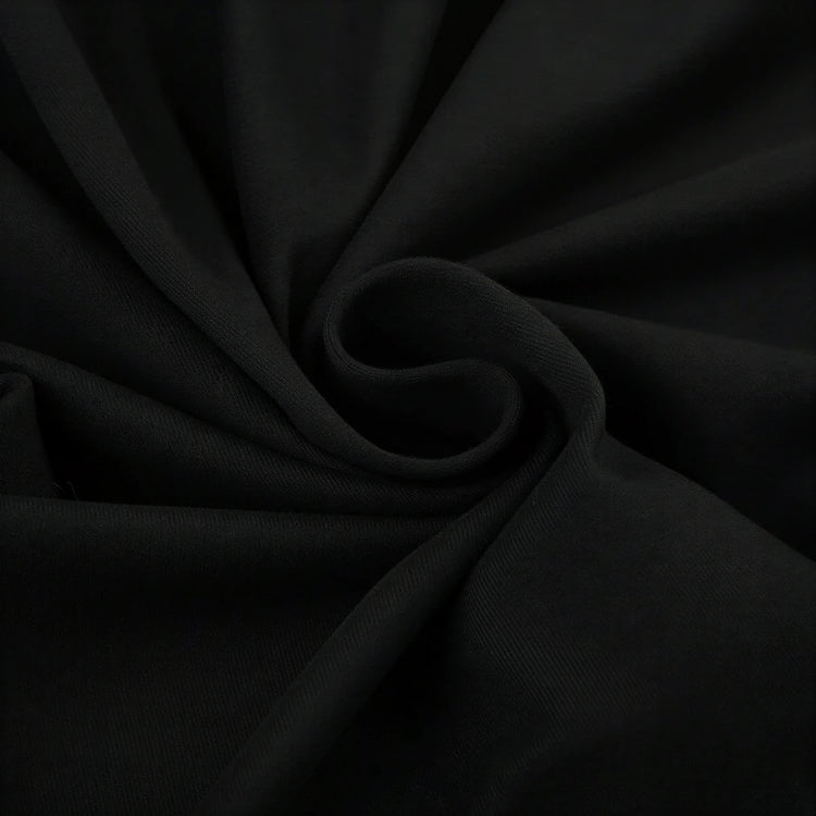 Backless mini dress in black, soft fabric with subtle texture and gathered detail.
