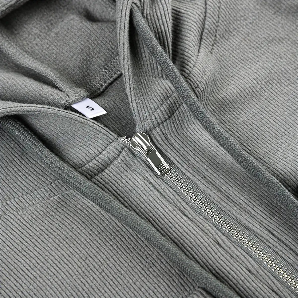 Grey corduroy zip-up dress with silver zipper and size tag.