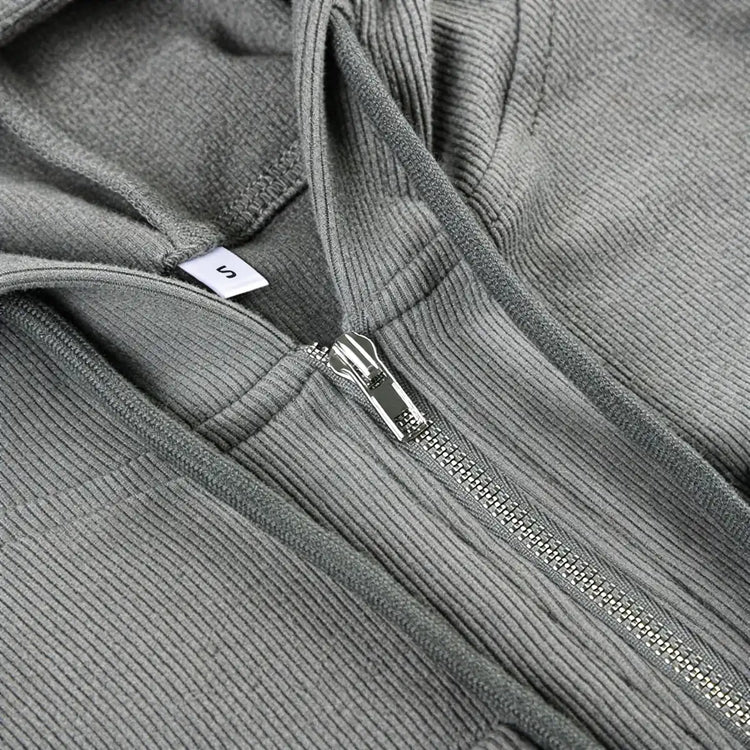 Grey corduroy zip-up dress with silver zipper and size tag.