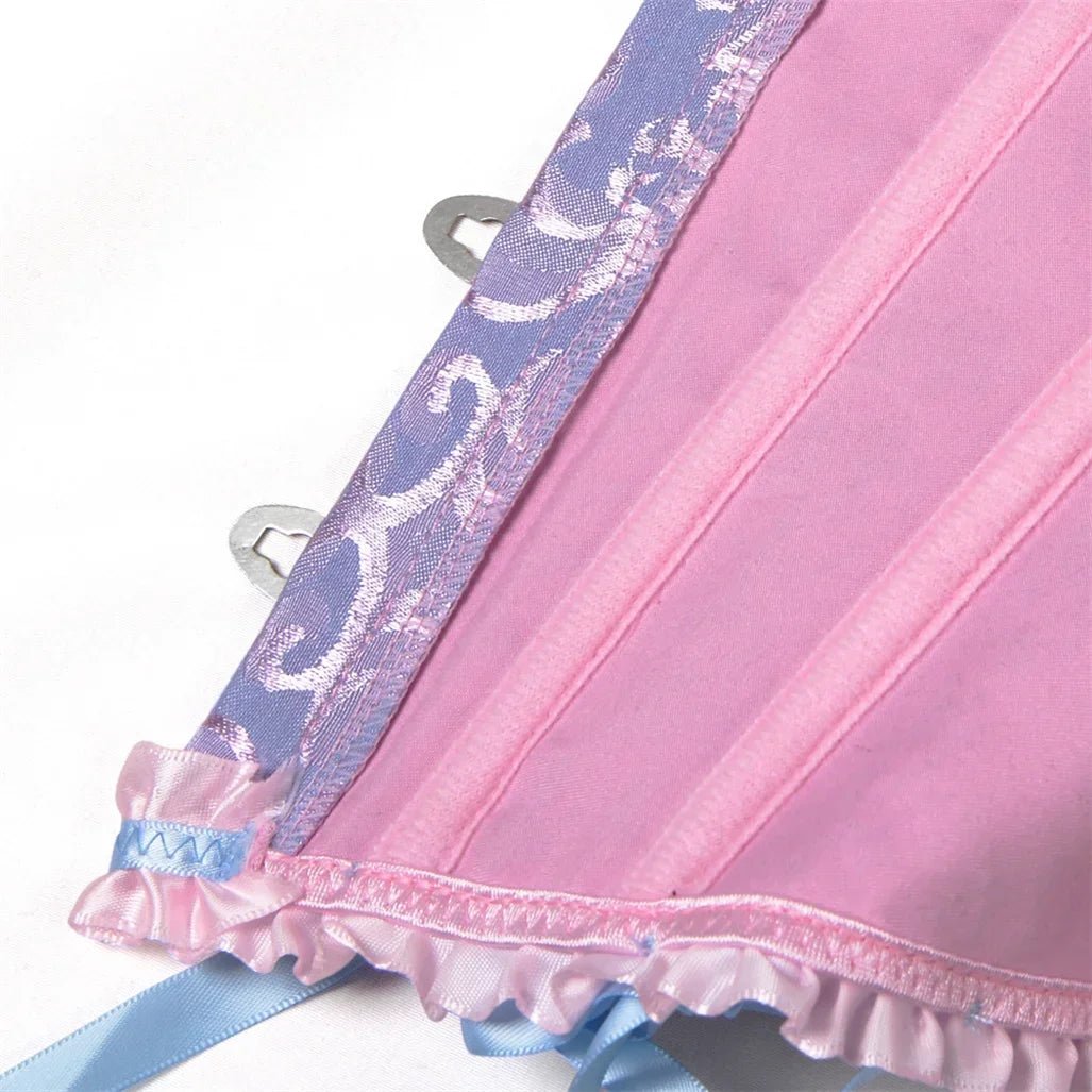 Dream Wanderer Corset in pink satin with lace trim and ruffled hem.