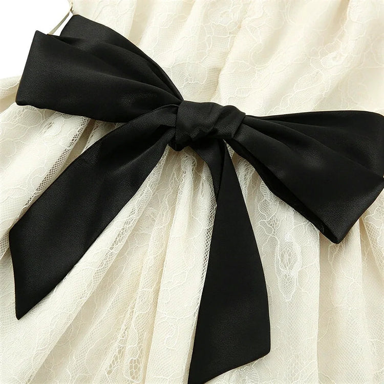 Fairy Hunter Lace Dress: cream lace with black satin bow at waist.