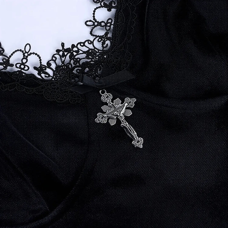 Black velvet dress with lace trim and silver cross pendant.