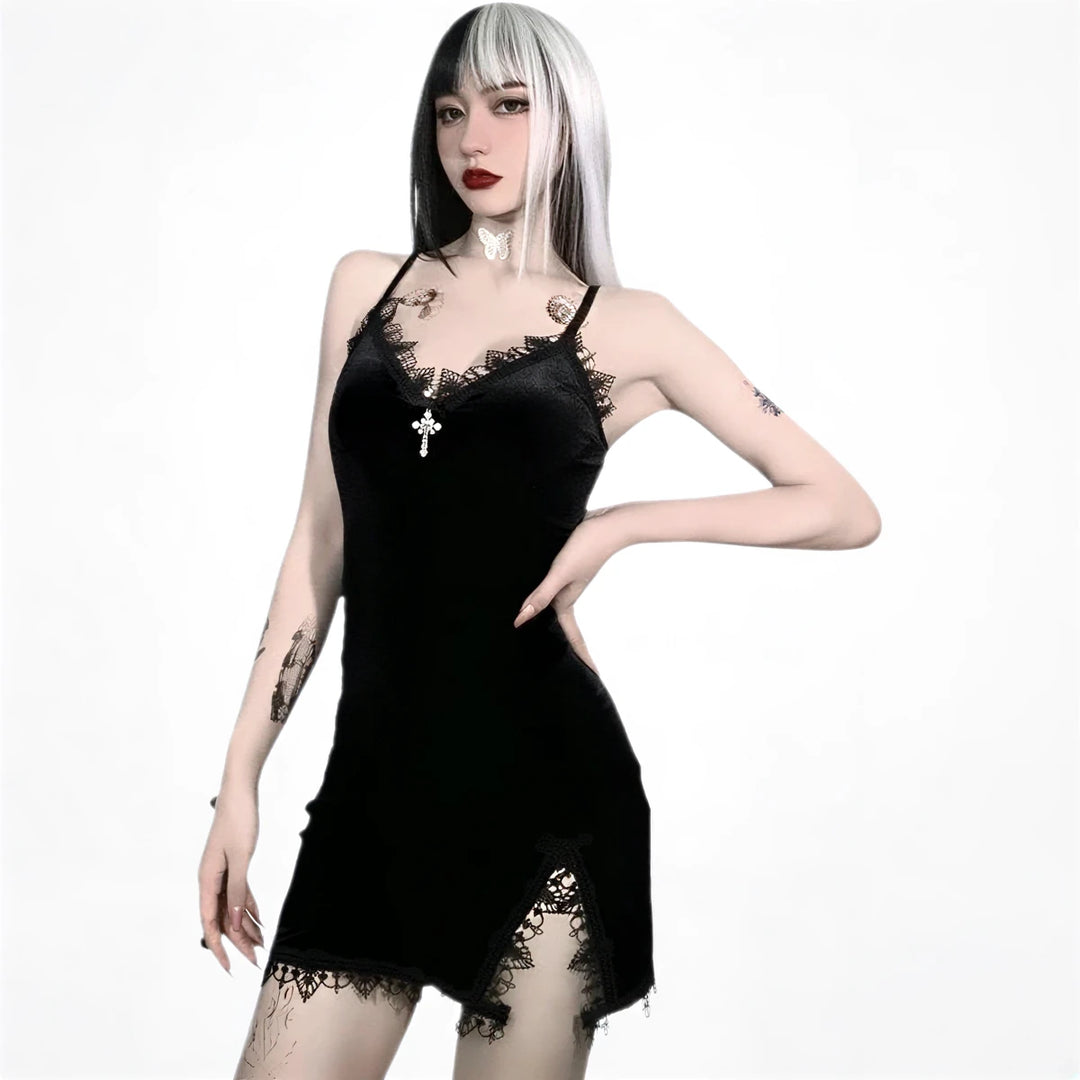 Black velvet slip dress with lace trim and cross pendant detail.