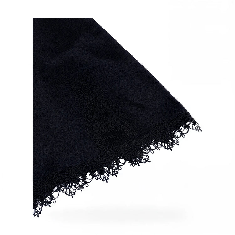 Black velvet dress with lace trim and fringed hem.