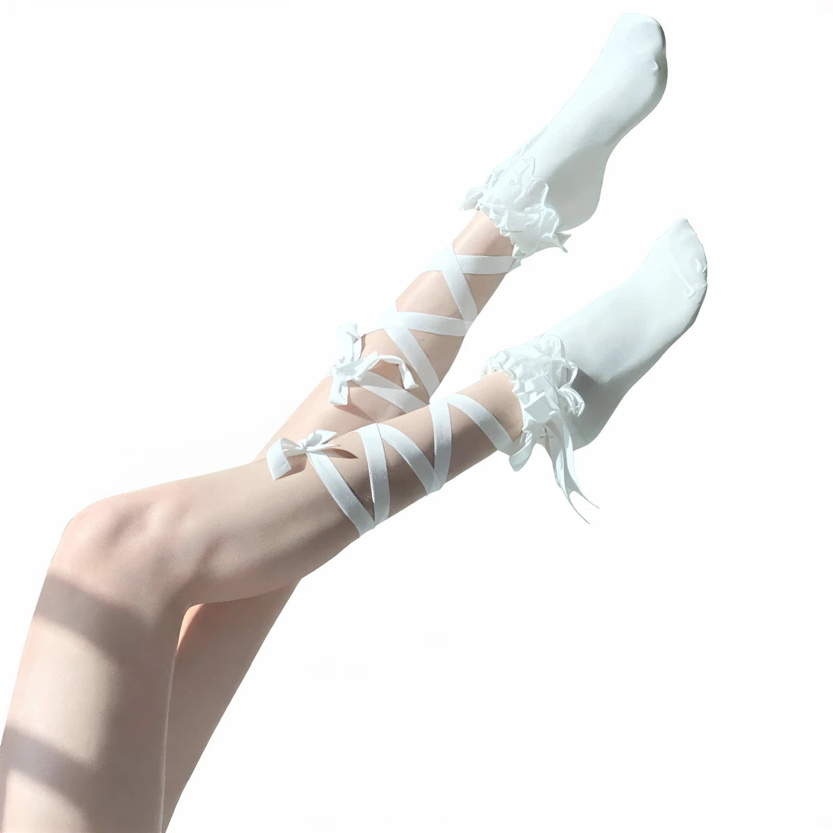 White ribbon cross tie socks with lace trim and bow accents.