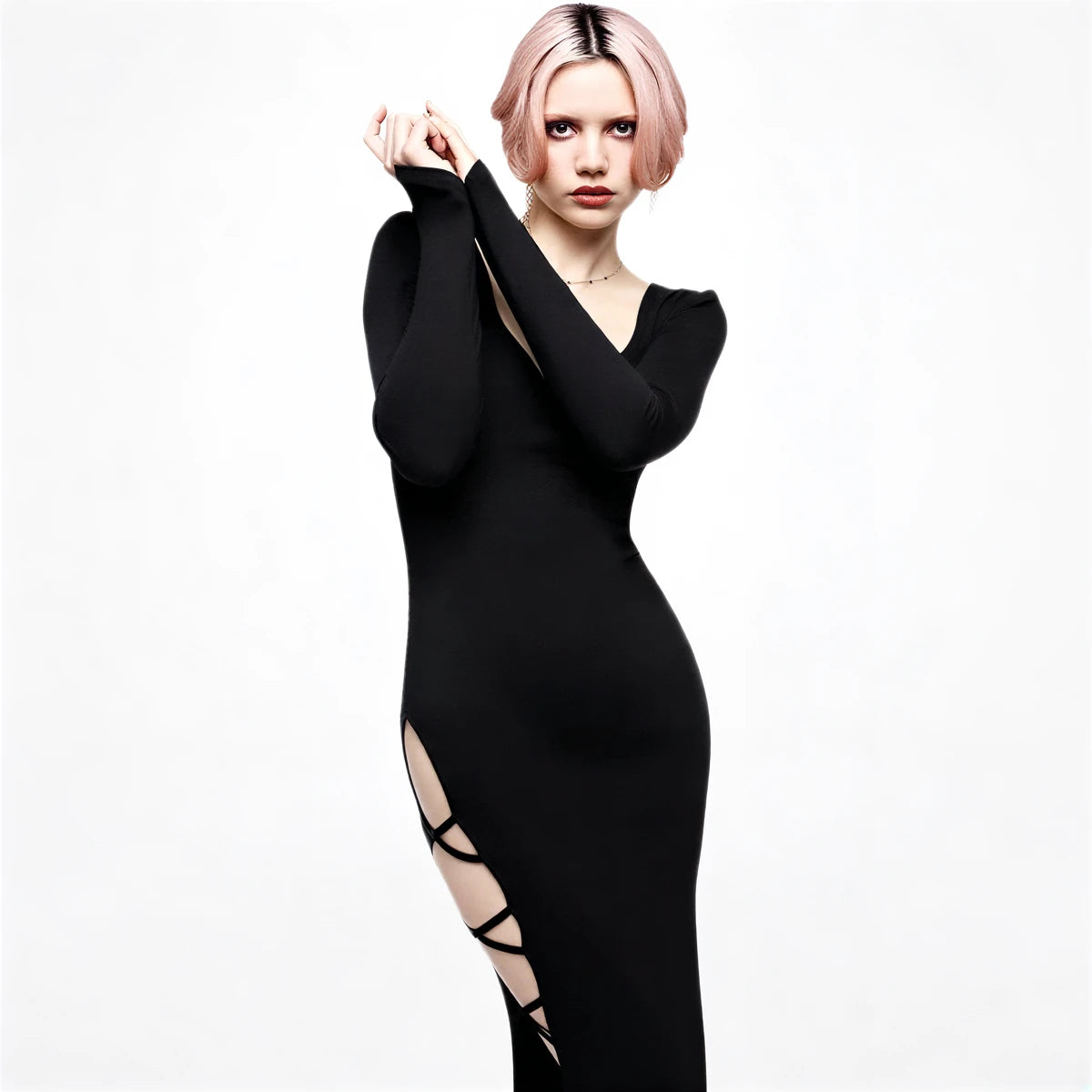 Black midi-length gown with side cutouts and long sleeves.