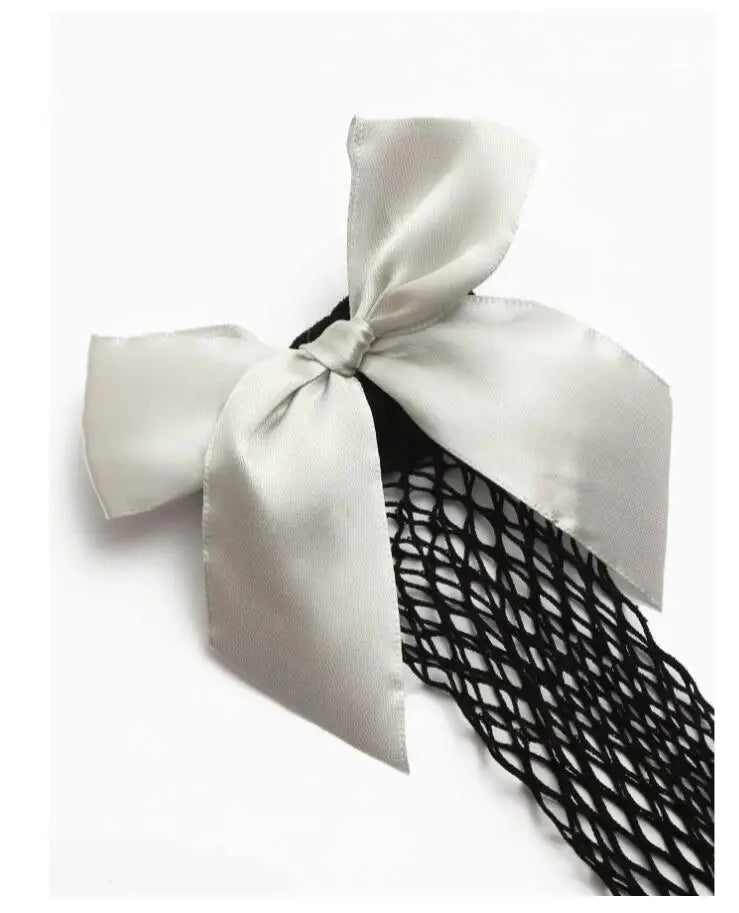Fishnet socks with white satin bow, black mesh, two pairs.
