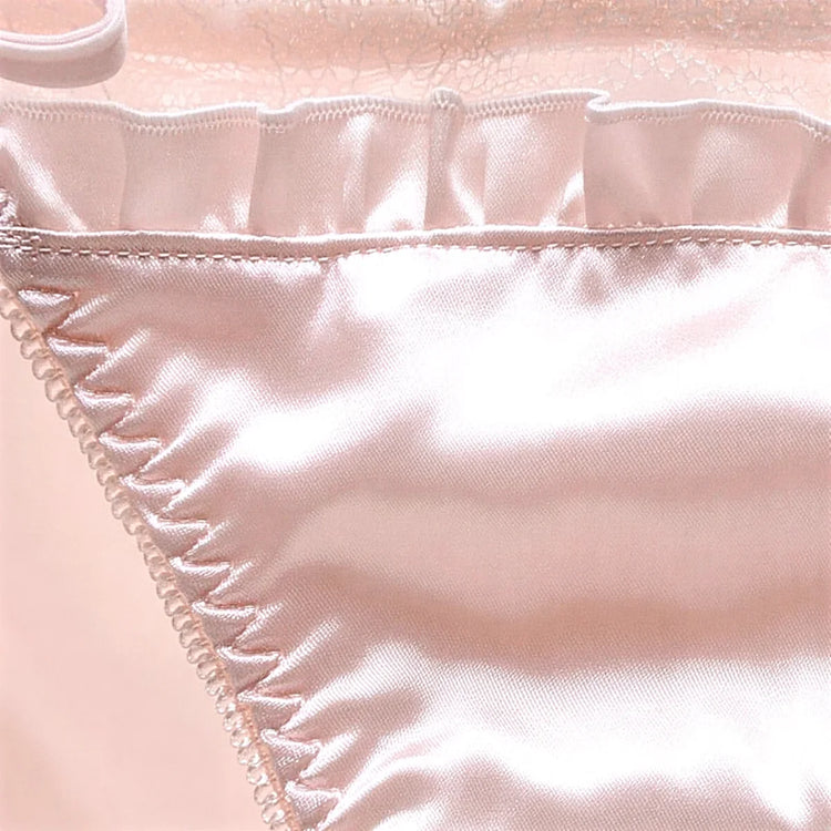 Pink satin panties with ruffled trim and pearl-stitched edge.