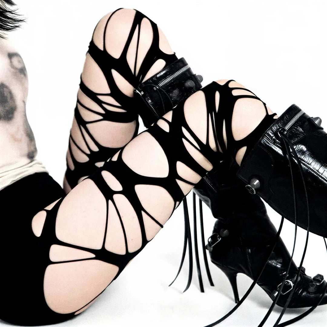 Black lace-up leggings with cutouts and zipper accents.