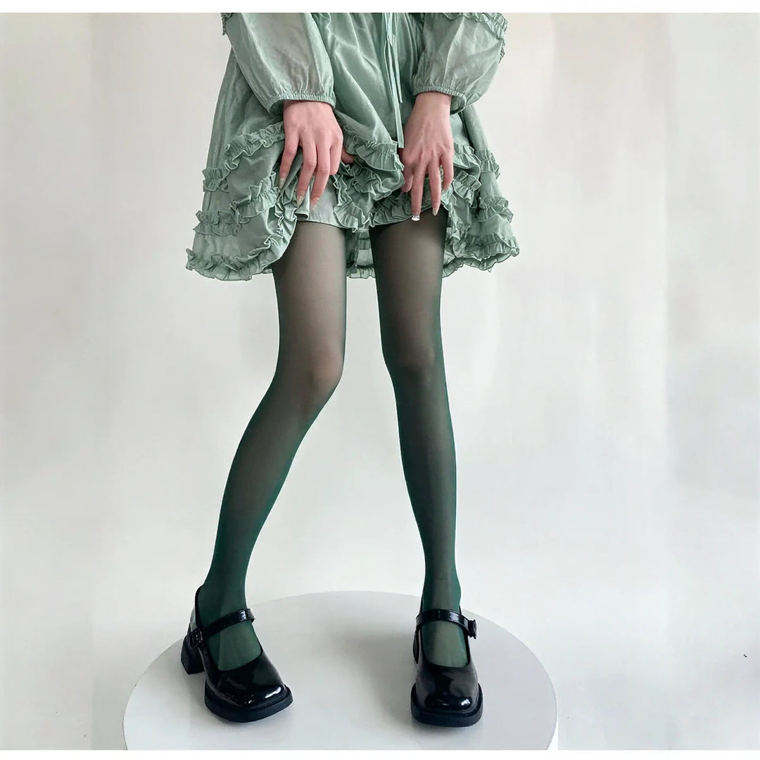 Vibe Legwear: sheer dark green tights with subtle sheen and smooth texture.