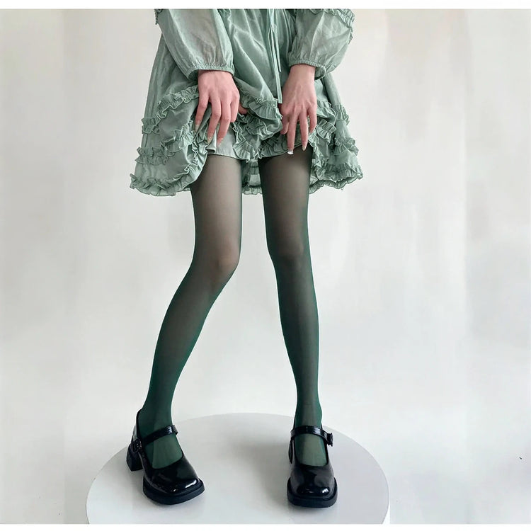 Vibe Legwear: sheer dark green tights with subtle sheen and smooth texture.