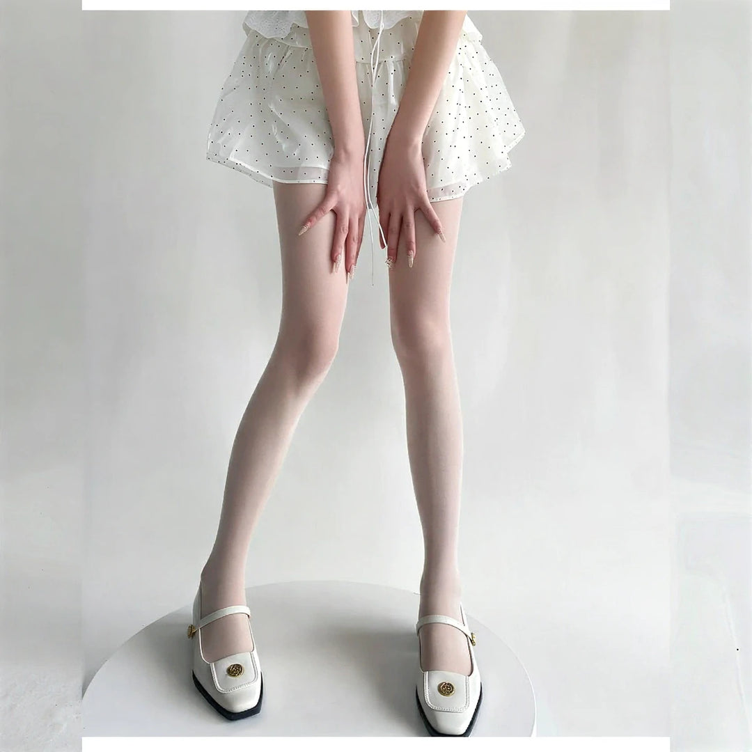 Vibe Legwear: sheer white stockings with subtle dot pattern and smooth texture.