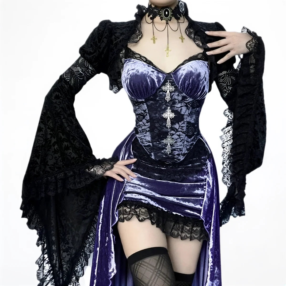 Victoria velvet dress in purple, featuring lace trim and cross embellishments.